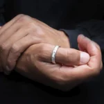 Alianza de plata 925 Crisan Men2 usada en el pulgar con fondo oscuro